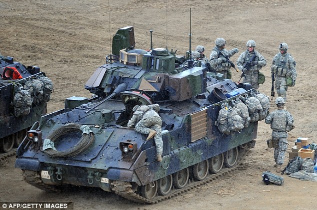 Final preparations: U.S. soldiers check their tank at a military training field near Seoul, South Korea as the Obama administration warned North Korea it is skating a 'dangerous line' with its proposed missile launch