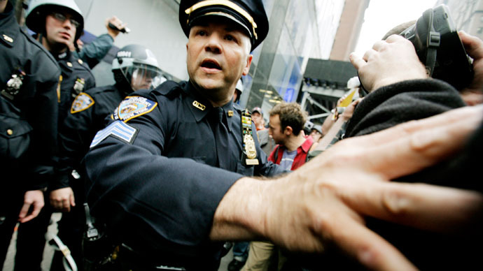 Members of the New York Police Department (NYPD) scuffle with protestors as they guard the entrance to a Citibank as Occupy Wall Street demonstrators march along 42nd Street to protest various businesses during May Day on May 1, 2012 in New York.(AFP Photo / Monika Graff)