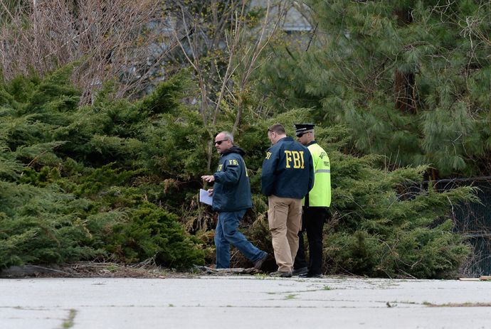 FBI investigators and Watertown Police officer walk in parking lot as they investigate the shooting scene near the boat where bombing suspect was hiding from police on Franklin Street on April 20, 2013 in Watertown, Massachusetts (Reuters / Kevork Djansezian)