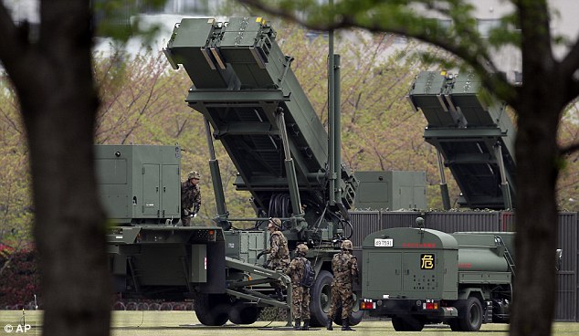At the ready: Japanese forces set up Patriot anti-missile defence systems in Tokyo today as the threat level over a North Korea missile launch was raised to 'vital'