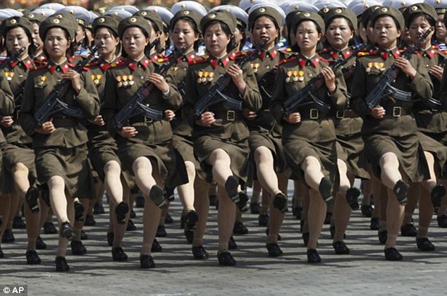 Goose-stepping girls: Propaganda songs have been written to attract more women into the coastal artillery units and women fighters now guard nearly all tunnels and bridges (file picture)