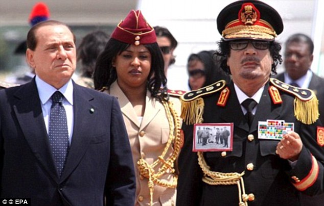 Trend-setter: The image of women in uniform sparked memories of Libyan dictator Muammar Gaddafi's distinctive band of female bodyguards, who wore sunglasses and headdresses and knee-boots