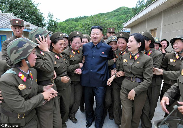 With the ladies: North Korean dictator Kim Jong Un with female members of the Korean People's Army Unit 4302 in an undated picture. Many of the artillery units along the coasts are manned with women