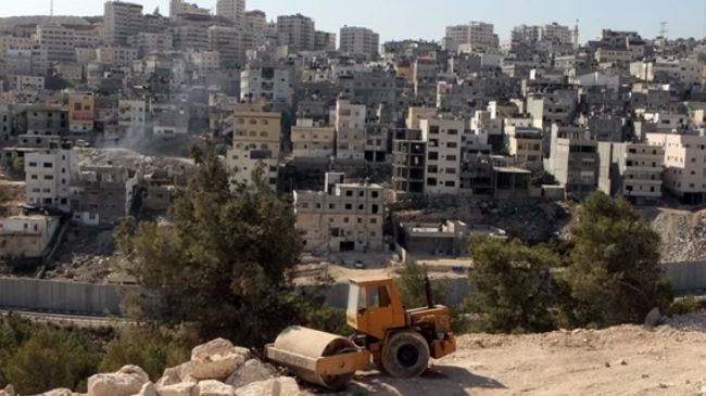 An Israeli bulldozer sits at a construction site in East al-Quds (Jerusalem). (file photo)